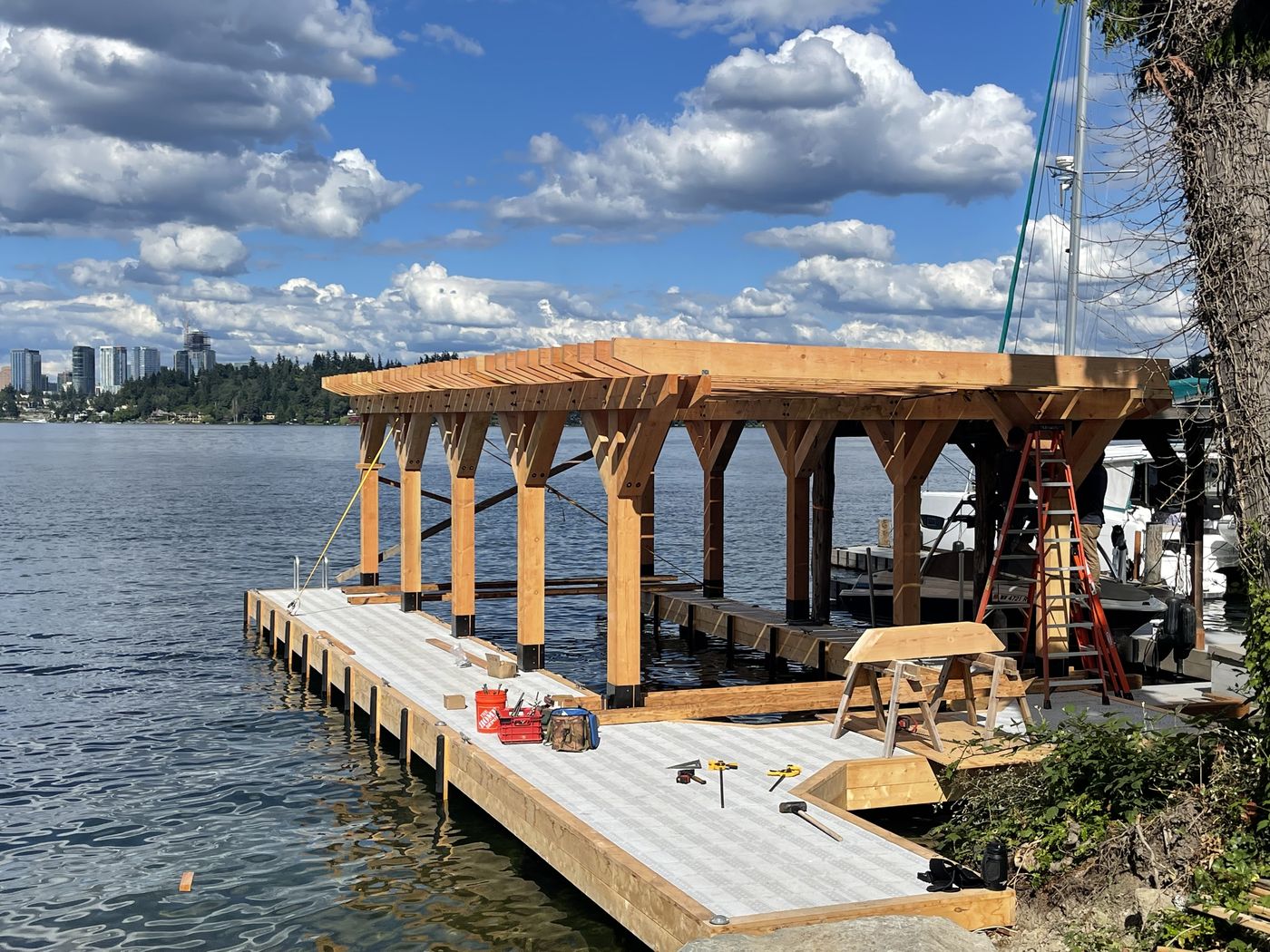 Heavy-timber frame raised over a Lake Washington dock, milled and engineered in-house