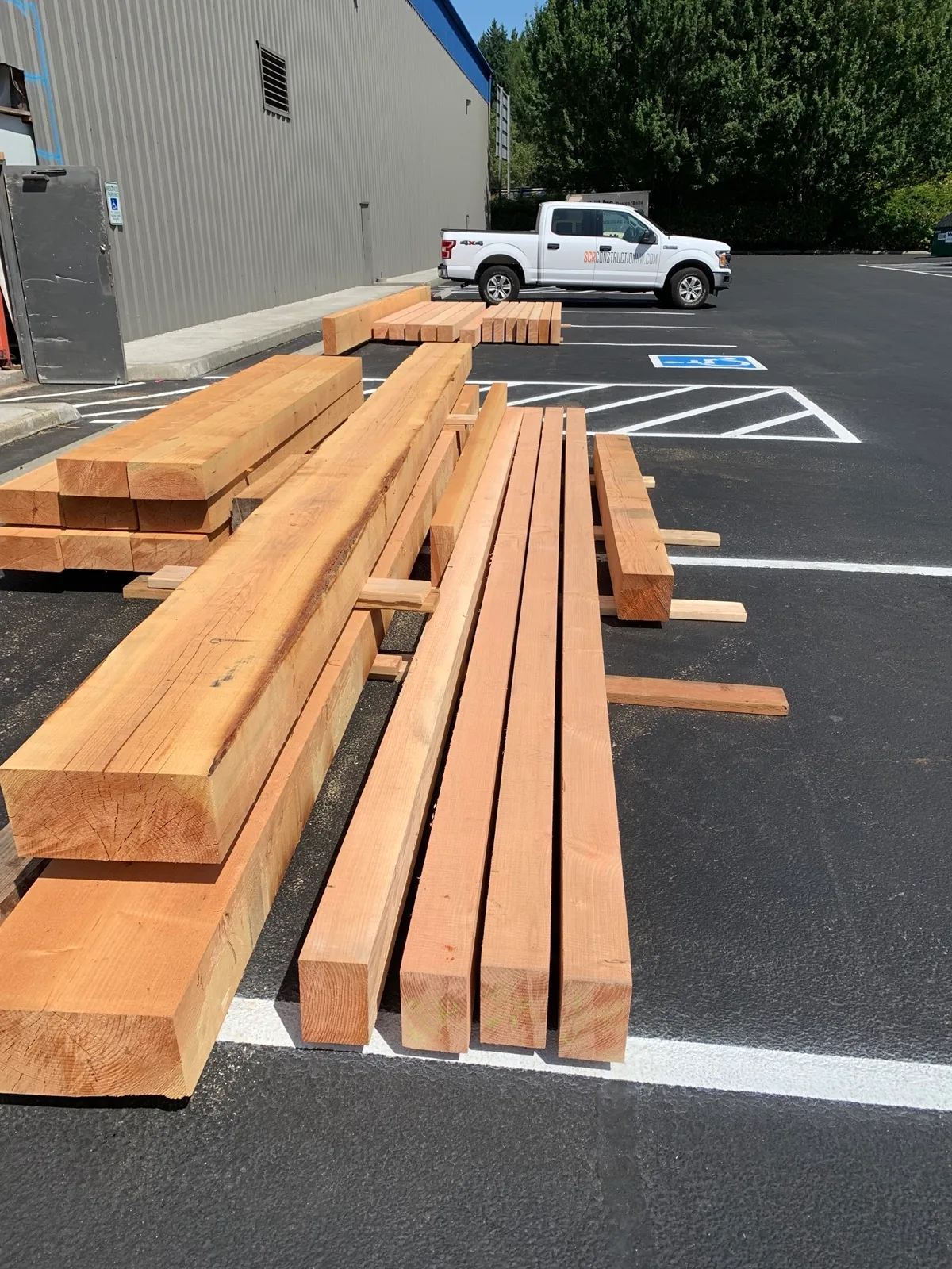 Structural Douglas Fir timbers staged for delivery to a Svensen build